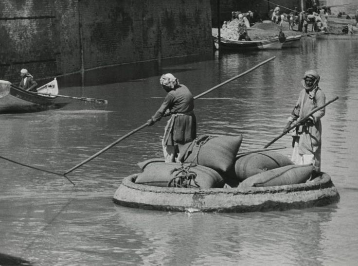 black and white image of a coracle-made of animal skins and covered with bitumen (waterproofing)